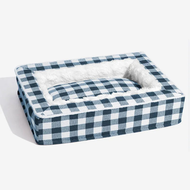 Classic plaid-patterned removable dog cushion for crate or kennel, shown in red, blue, black, or brown.