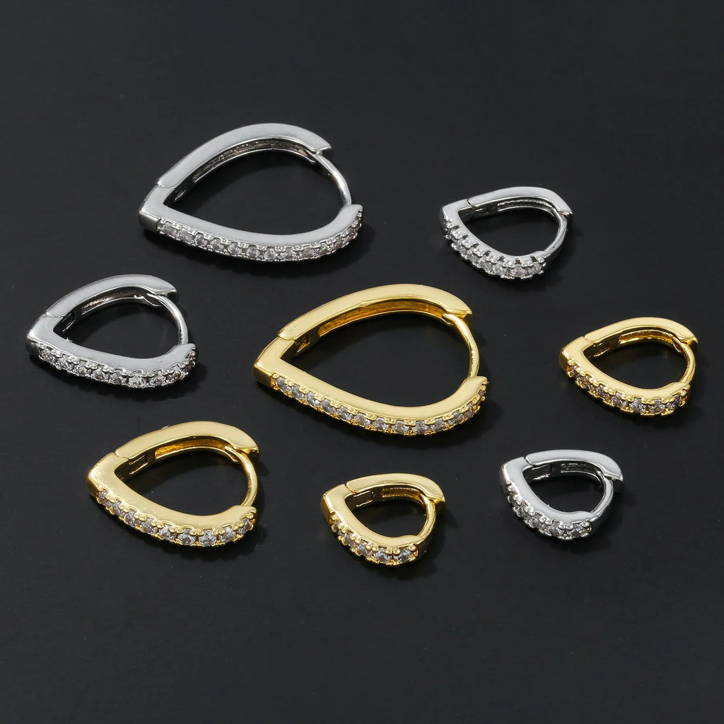 A geometric heart-shaped ear clip in a gold electroplated finish on a copper base.