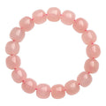 Natural pink crystal bracelet with geometric barrel-shaped beads measuring 8-10mm