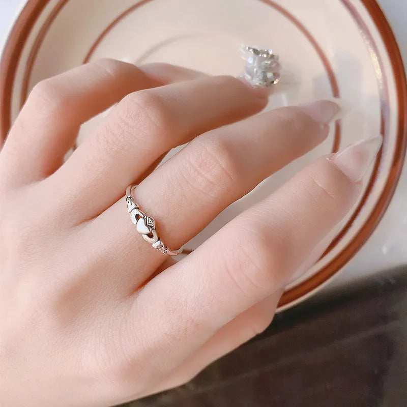 Retro silver heart open ring on finger showing adjustable copper construction and heart silhouette