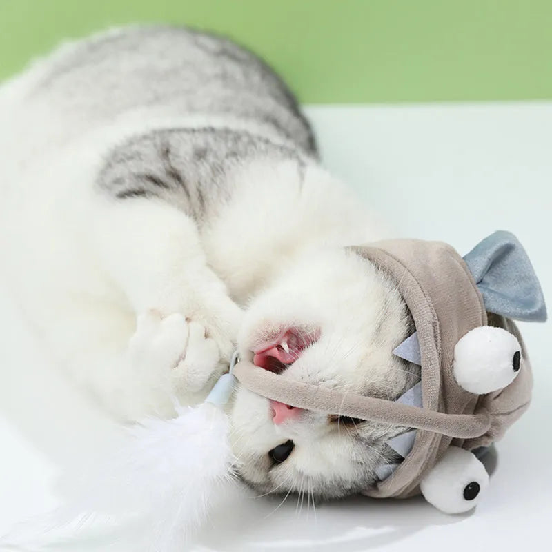 Grey cat teaser toy with adjustable headband, feather decoration, and big eye fish design