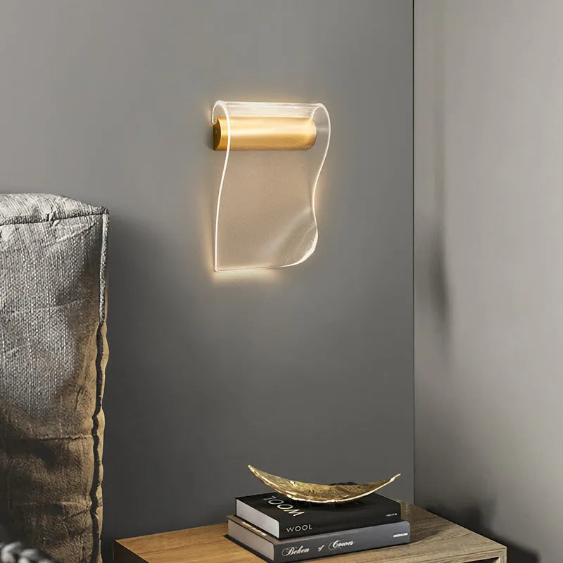 Simple wall lamp with a bendable arm and acrylic shade mounted on a wall.