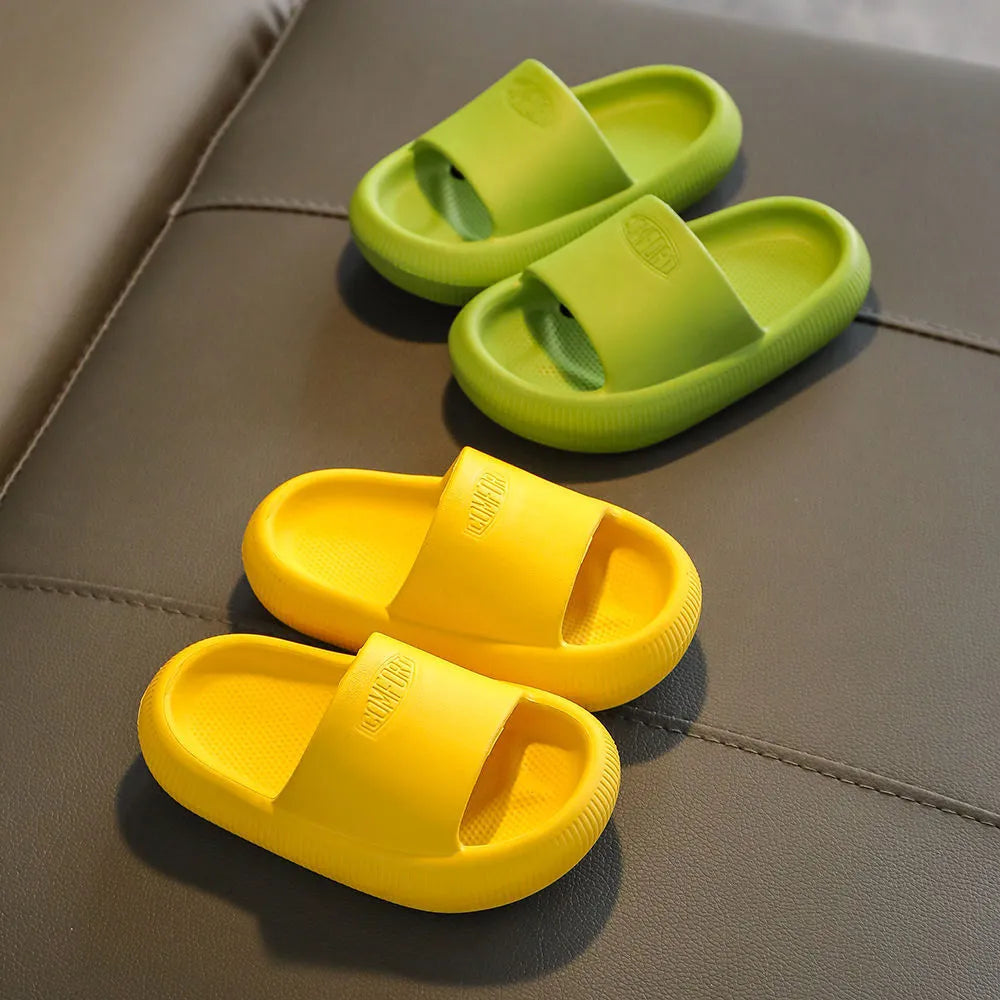 Children's colourful EVA slippers with a textured non-slip sole, shown in blue, green, orange, pink, and yellow.