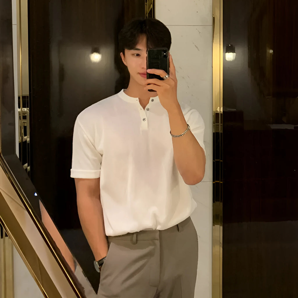 Man wearing a slim-fit black short-sleeved ice silk knitted pullover shirt.