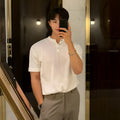 Man wearing a slim-fit black short-sleeved ice silk knitted pullover shirt.