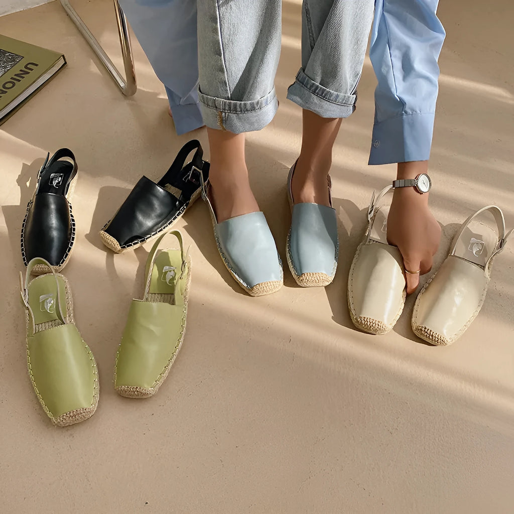Women's beige canvas baotou flat sandals with a retro fisherman style on a plain background.
