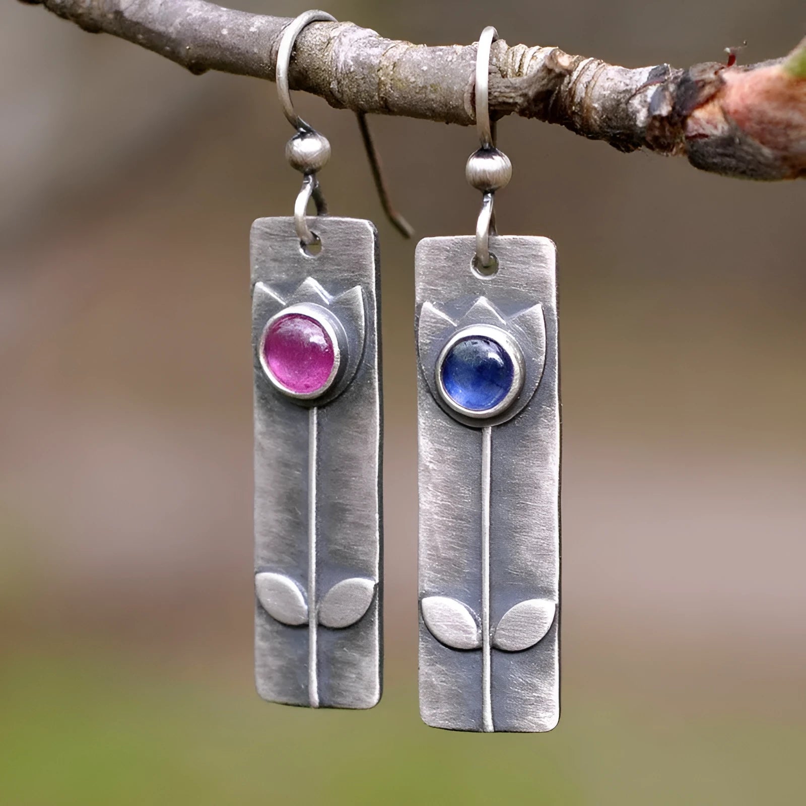 Antique finish geometric earrings with red sapphire stones and elliptical design elements