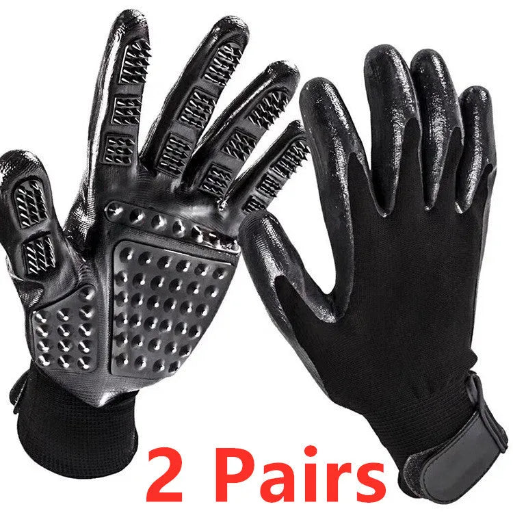 Pet hair grooming glove in black rubber with adjustable wrist strap on a light background