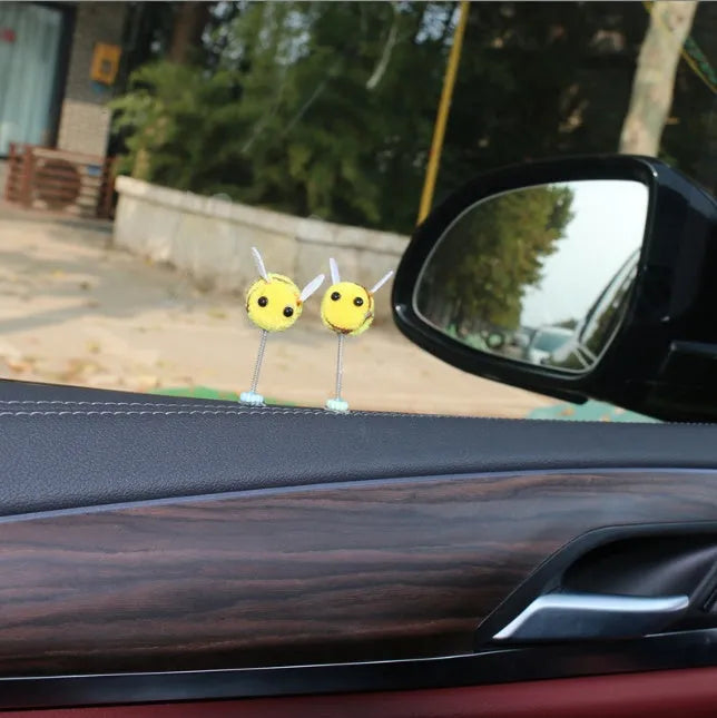 Swing Spring Bee soft fur ball car decoration with cartoon bee shape on adhesive backing.