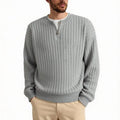 Man wearing a grey textured knit half-zip sweater with a loose fit and long sleeves.