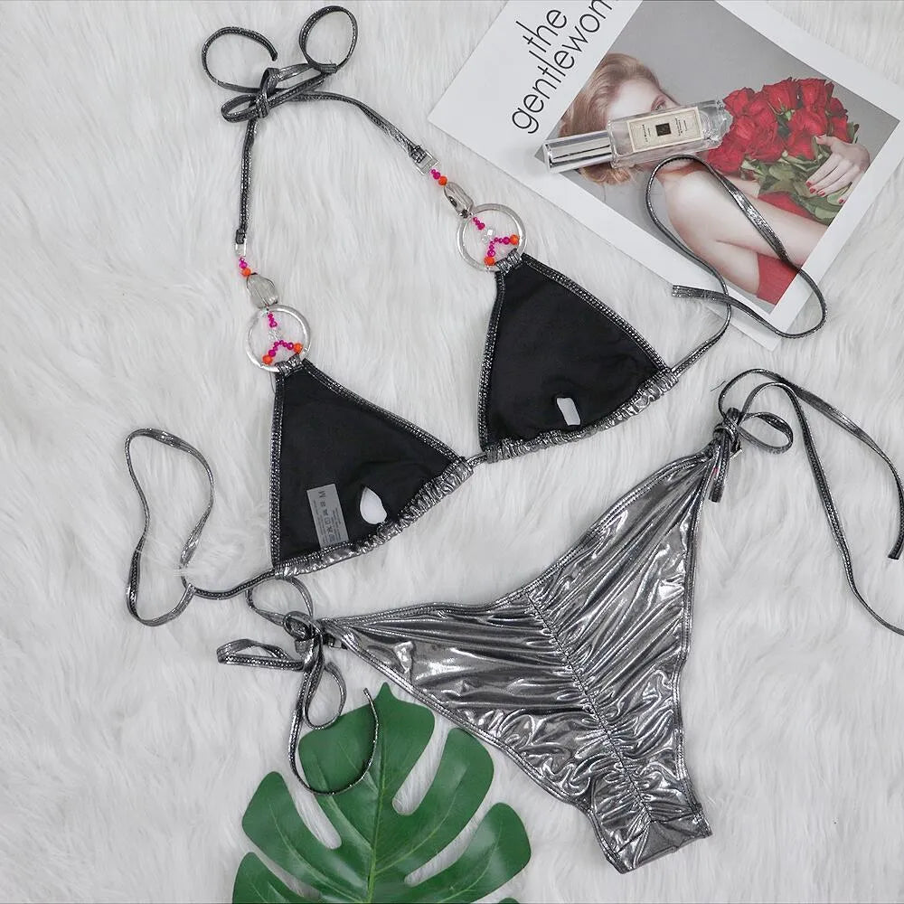 Silver women's two-piece bikini swimsuit with high-cut briefs on a mannequin.