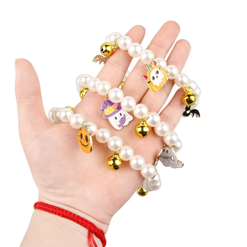 Halloween cat collar with simulated pearl necklace decoration showing pumpkin designs including purple ghost, skull, and smiling pumpkin patterns