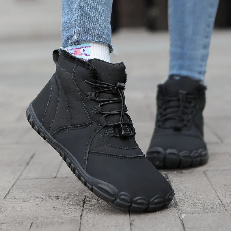 A pair of black outdoor snow boots with a lace-up front and a round toe on a non-slip rubber sole.