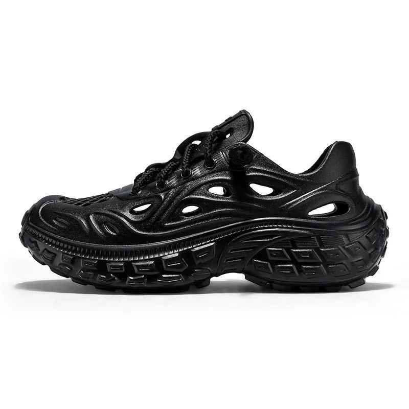 Men's black perforated EVA sandals with a thick sole and covered heel on a wooden deck.
