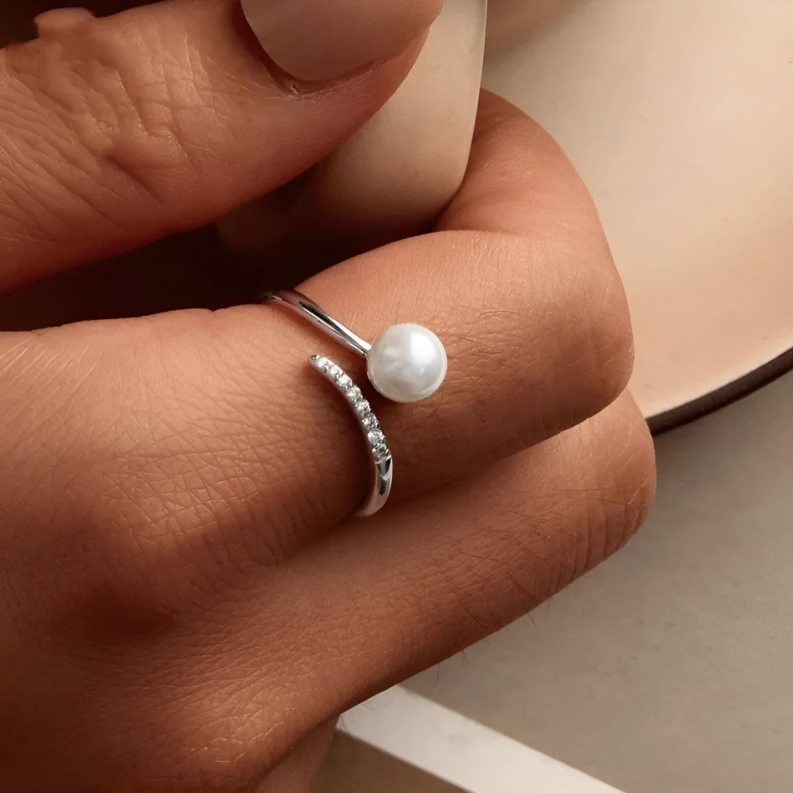 Women's sterling silver adjustable ring with shell pearls on open loop design