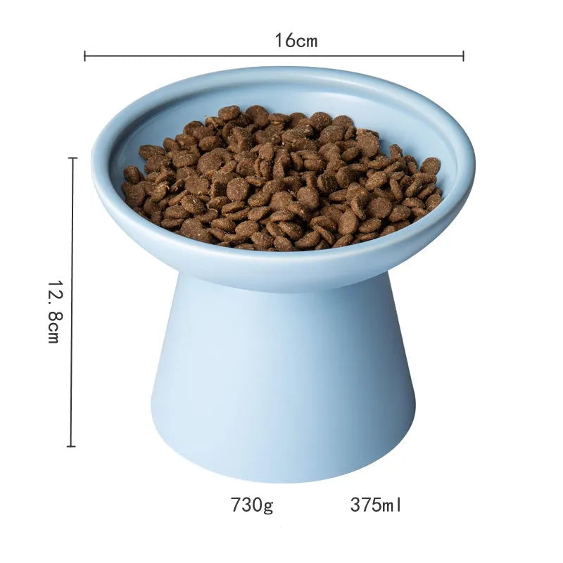 Blue elevated ceramic cat food bowl on a white surface