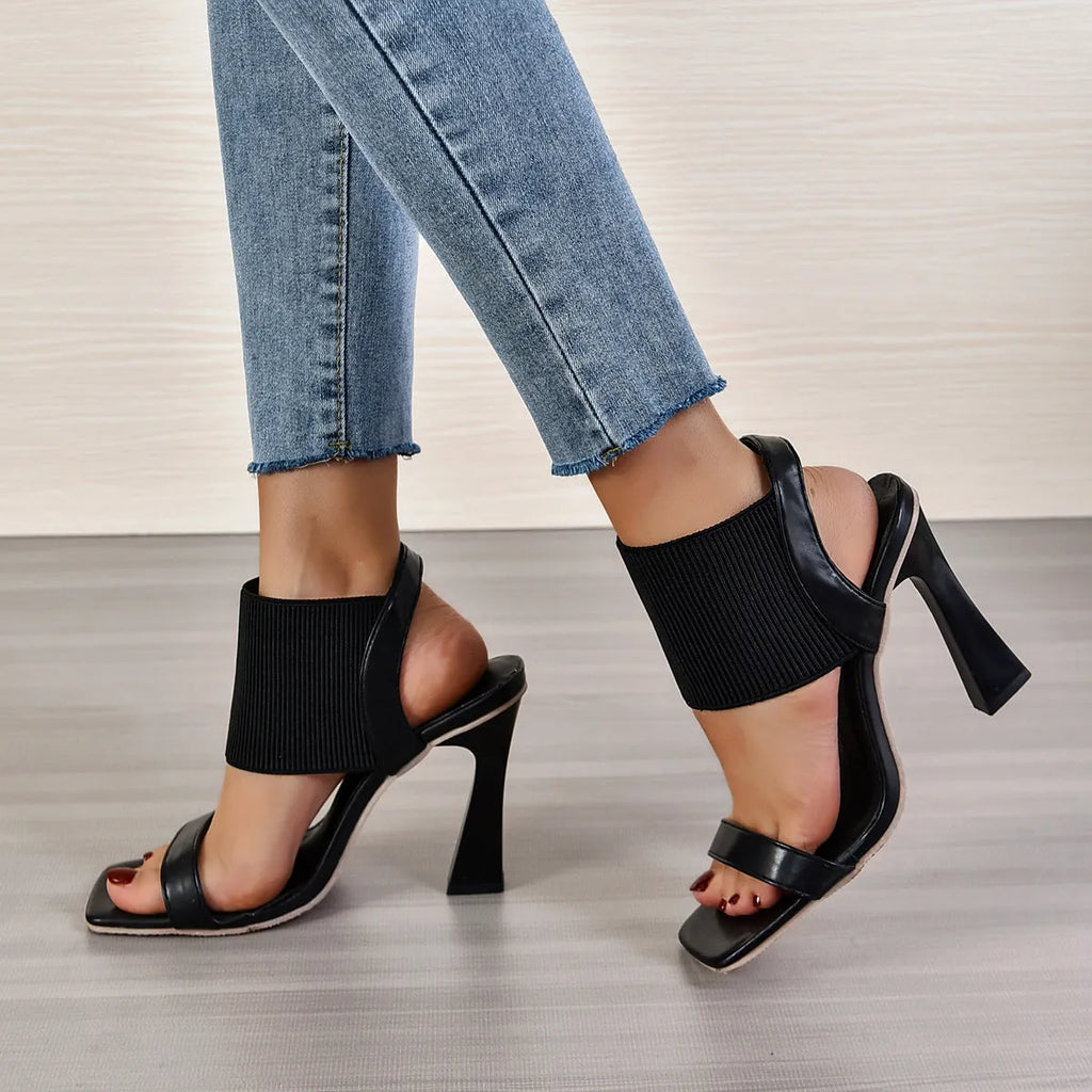 Women's black high heel sandals with elastic straps and rubber soles