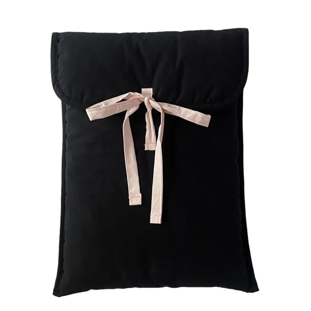 Women's black and white striped quilted laptop bag with a large ballet-style bow on the front.
