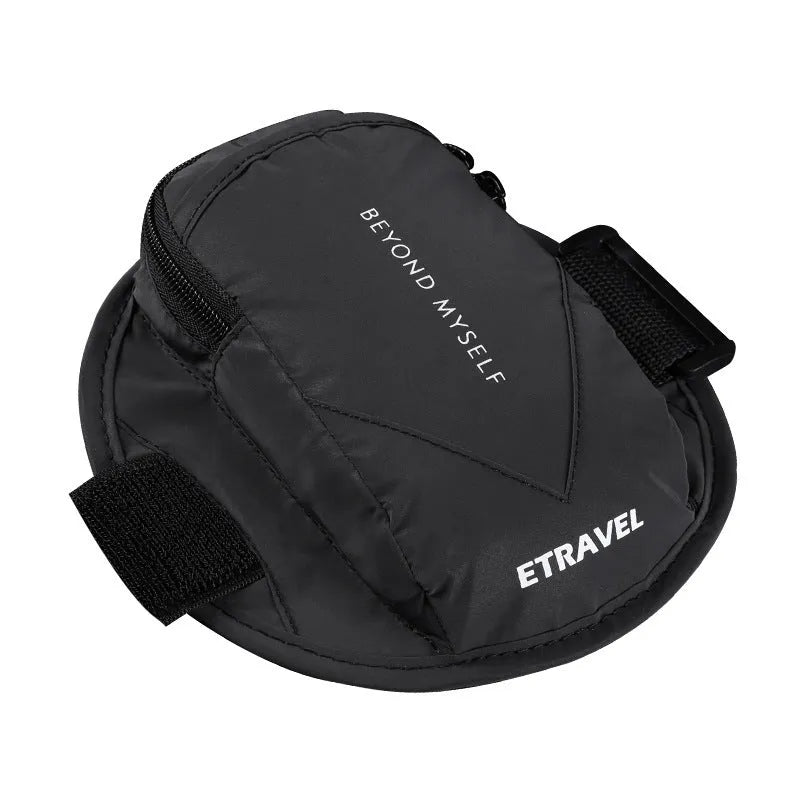 Black reflective running arm band wrapped around an arm, showing its strap and phone compartment.