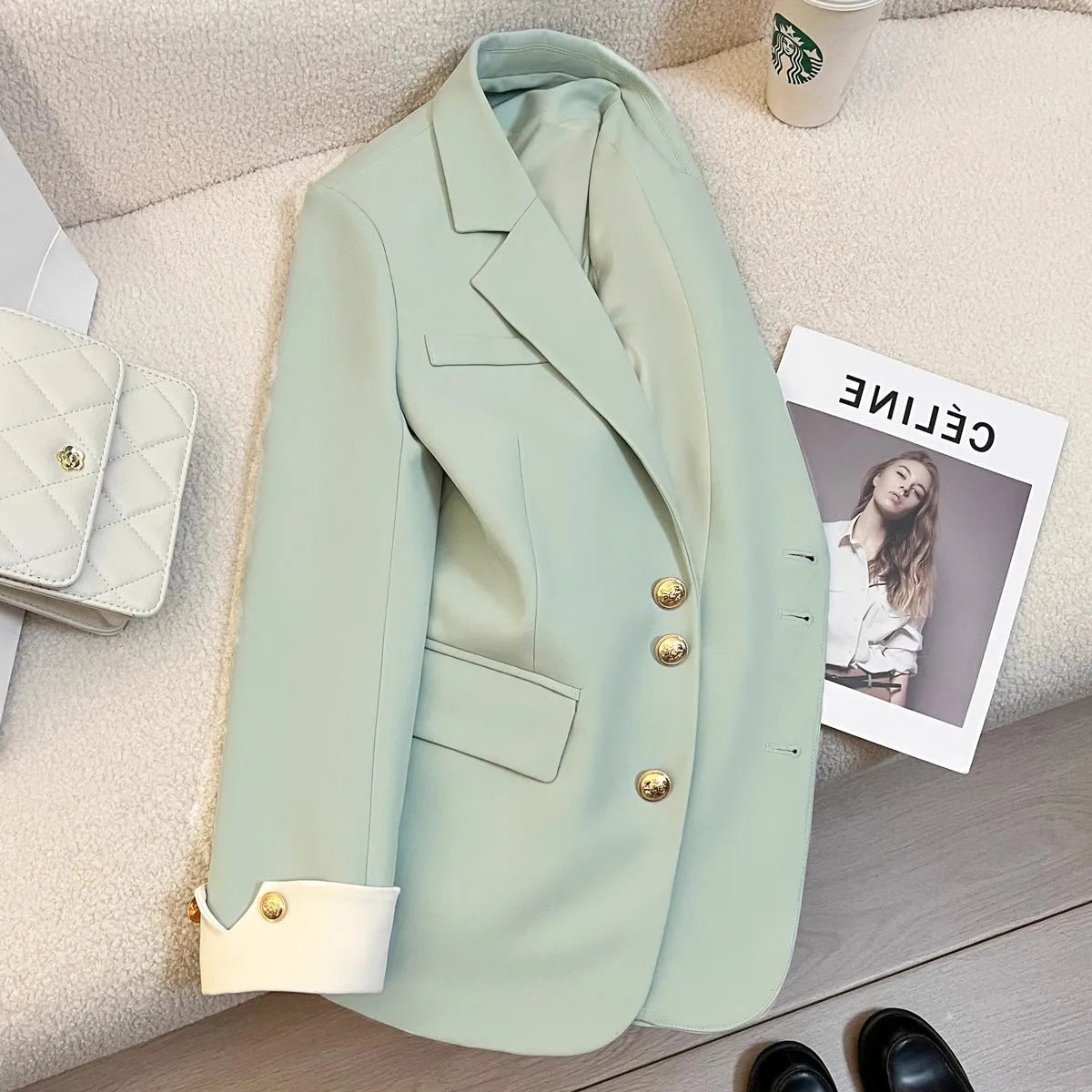 Korean style loose fit women's coat in milky white, showing long sleeves and pockets.
