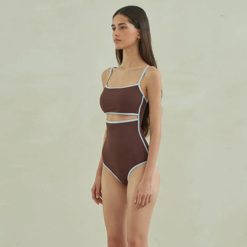Brown women's one-piece swimsuit with a triangular style on a mannequin