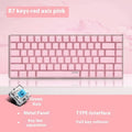 82-key mechanical keyboard with white backlight and metal housing beside laptop