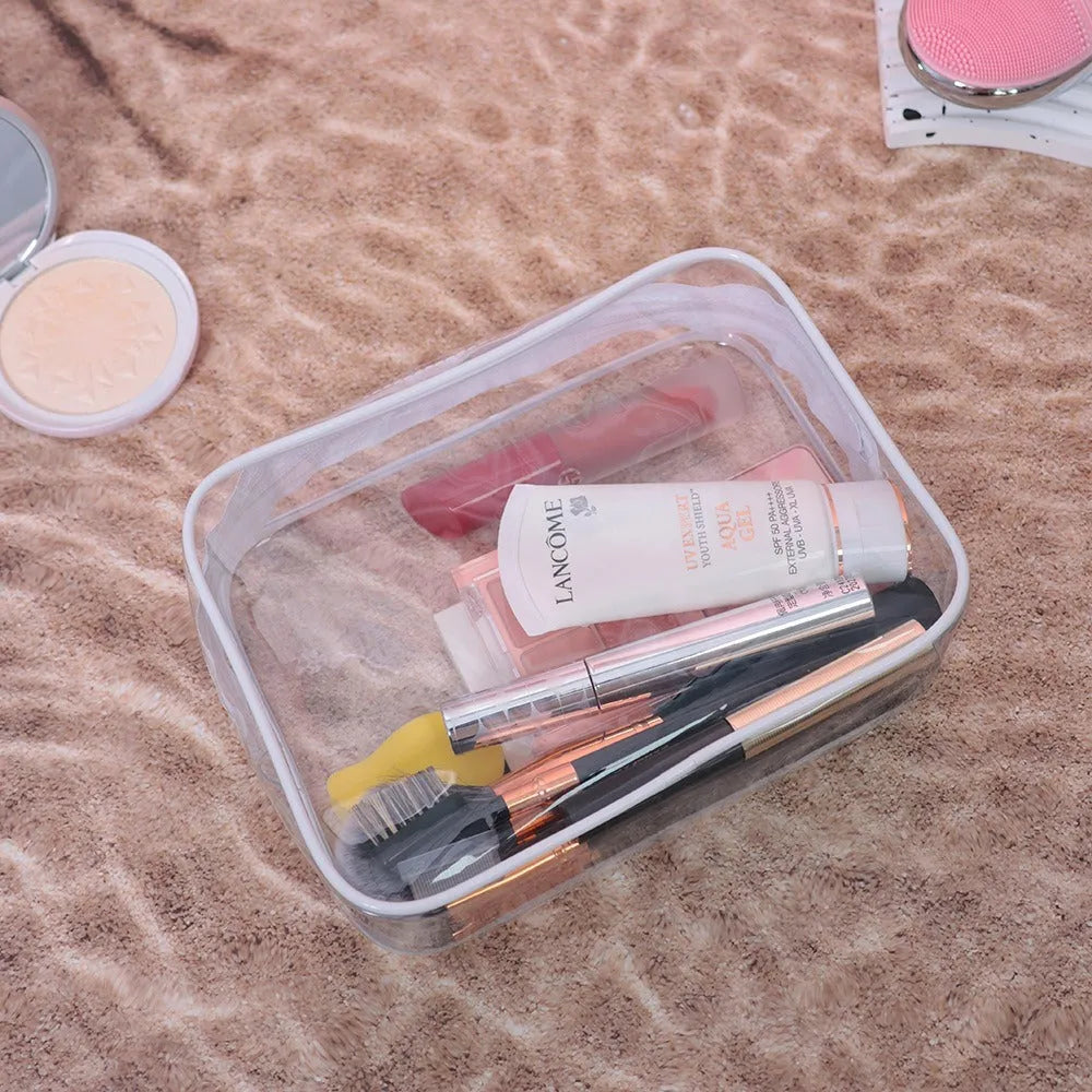Set of three semi-transparent PVC makeup bags in pink with Labubu stickers, showing large and extra-large sizes.
