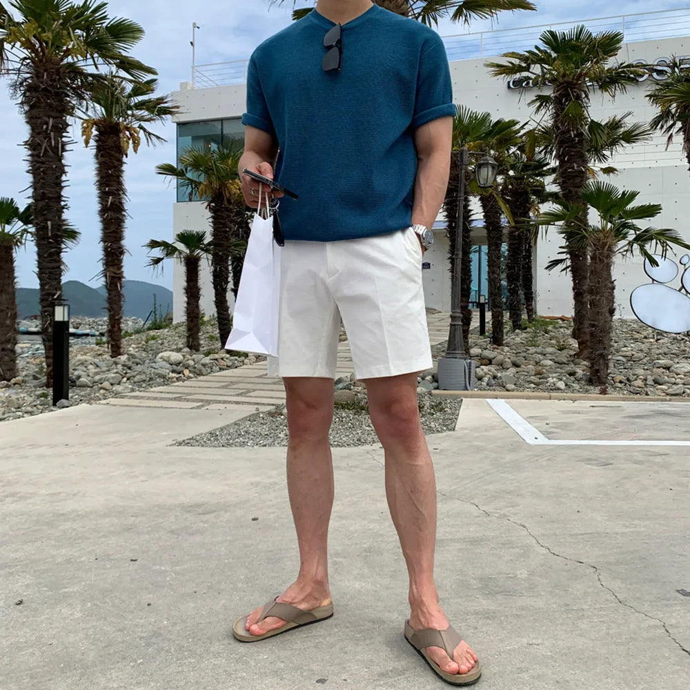 Man wearing loose straight-cut casual polyester shorts in a solid colour.