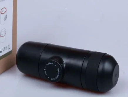 Black portable manual coffee machine showing compact 6cm design with pressure system for travel brewing