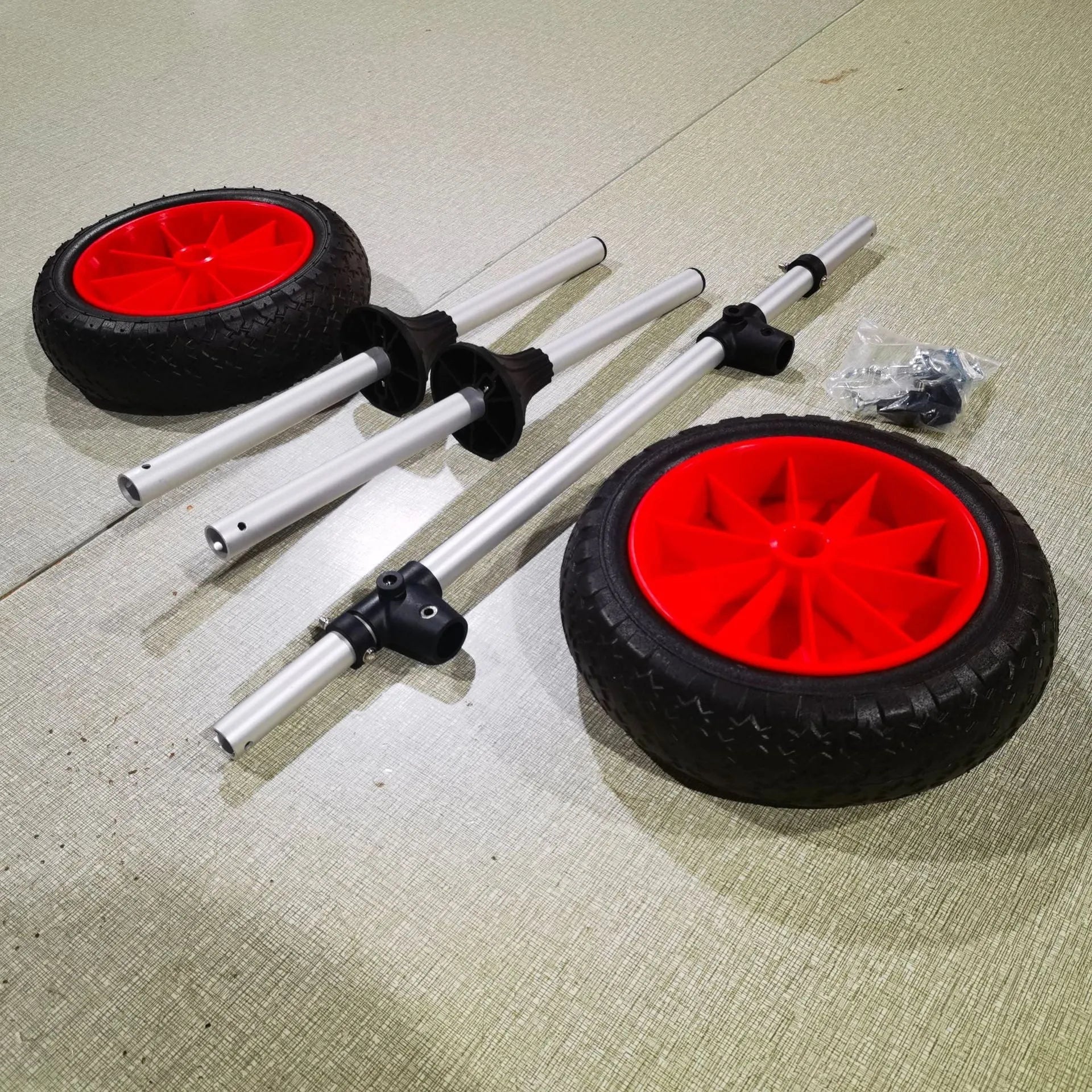 Foldable aluminium kayak cart with upright pole platform on a beach.