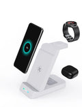 Black and white 65W fast wireless 3-in-1 charging stand for phone, watch, and AirPods on a desk.