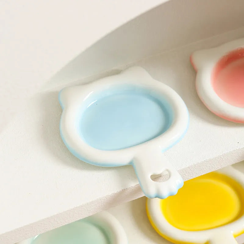 Ceramic cat bowl in blue, green, pink, or yellow colour options, shown in large and small sizes with shallow mouth design.