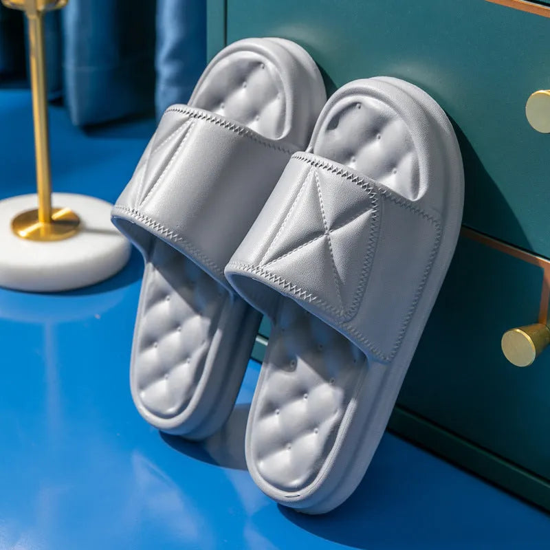 A pair of soft EVA couples bath sandals with a thicker sole, shown in a choice of colours on a bathroom floor.
