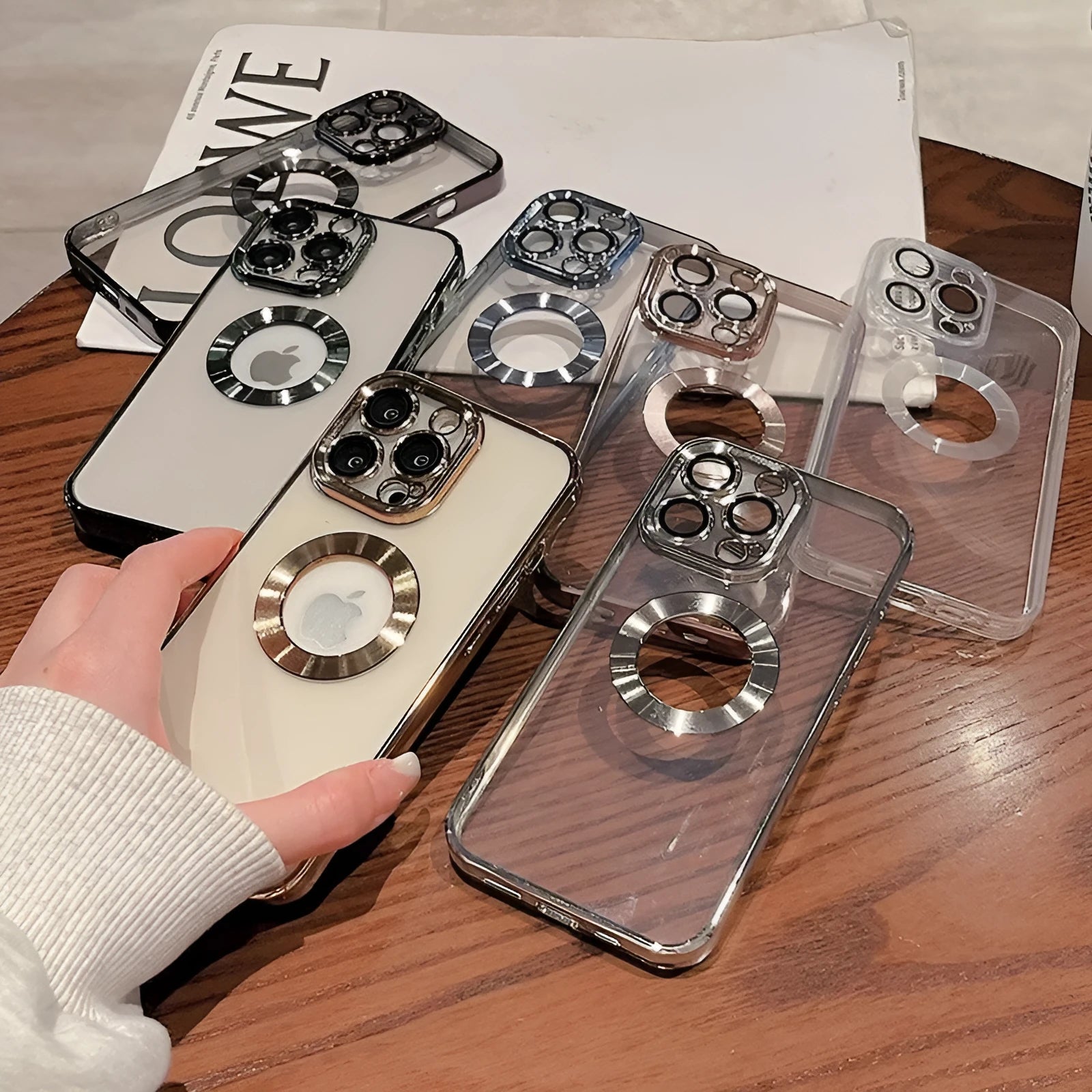 Electroplated silicone iPhone case with integrated camera lens protector shown in transparent finish