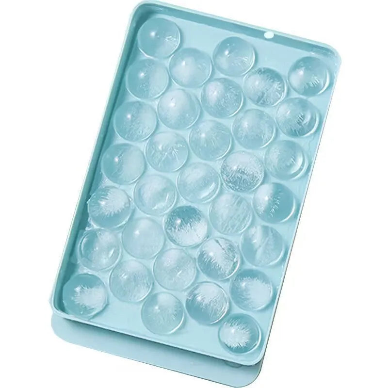 Blue silicone ice cube tray with lid showing 33 round moulds for large ice cubes