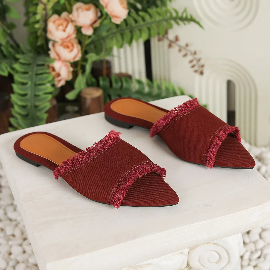 Women's denim flat slippers with tassel detail in multiple colours showing leather lining and PVC sole