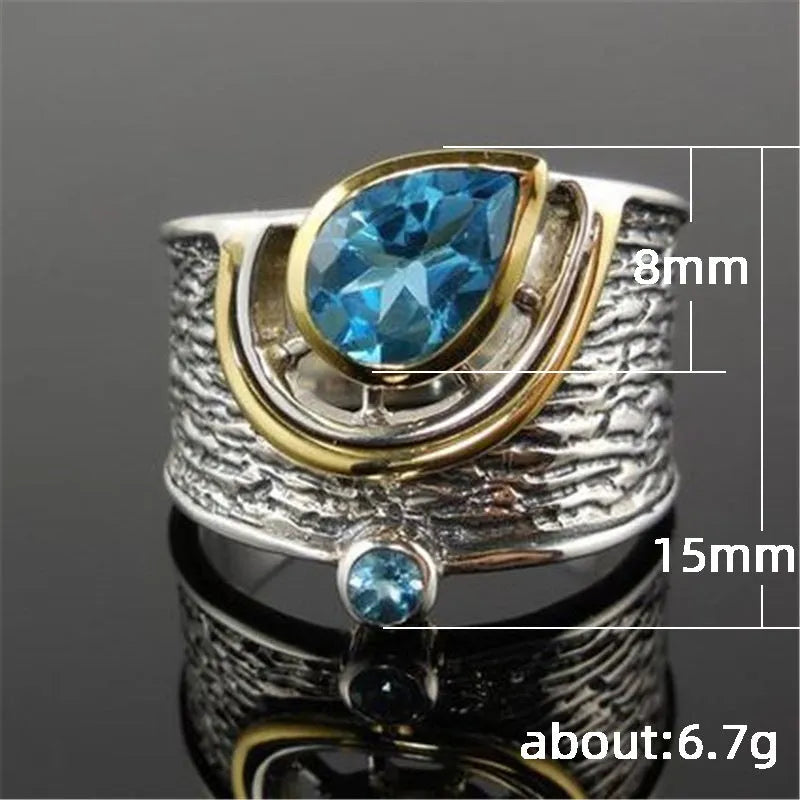 Women's blue zircon drop shape alloy ring with Chinese style design on a white background.