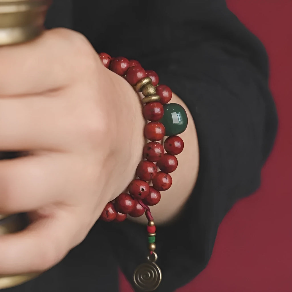 Handmade bodhi seed double circle bracelet with cartoon style on a wrist.
