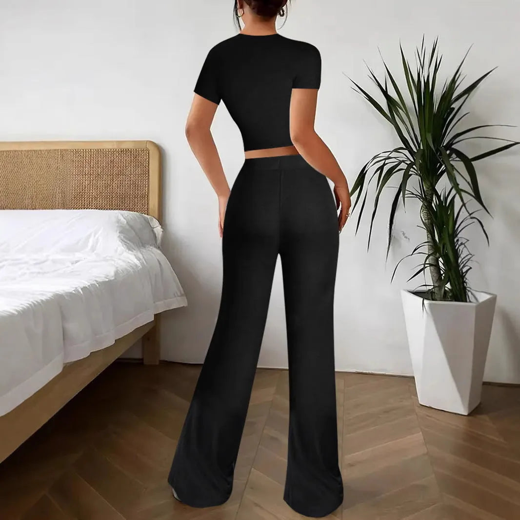 Black high waist trousers and short sleeve t-shirt co-ord suit set on a hanger.