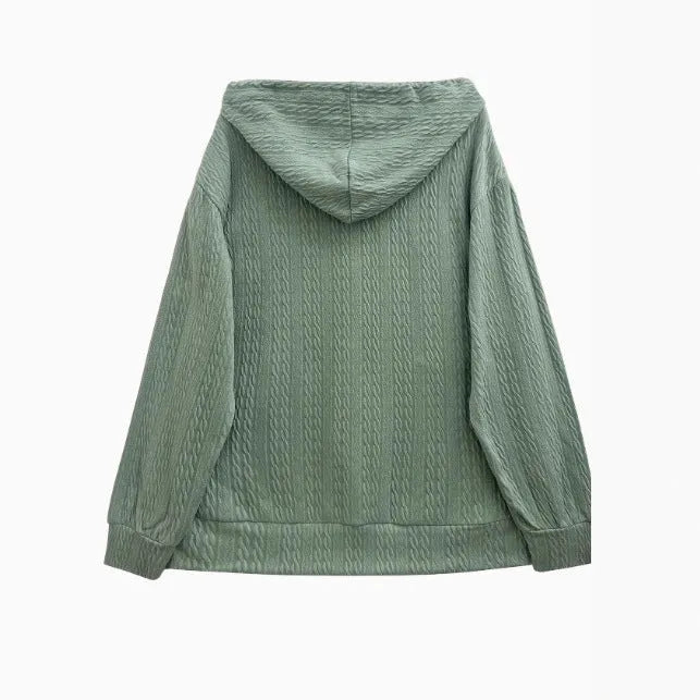 Green women's hooded zipper coat with a loose fit on a hanger.