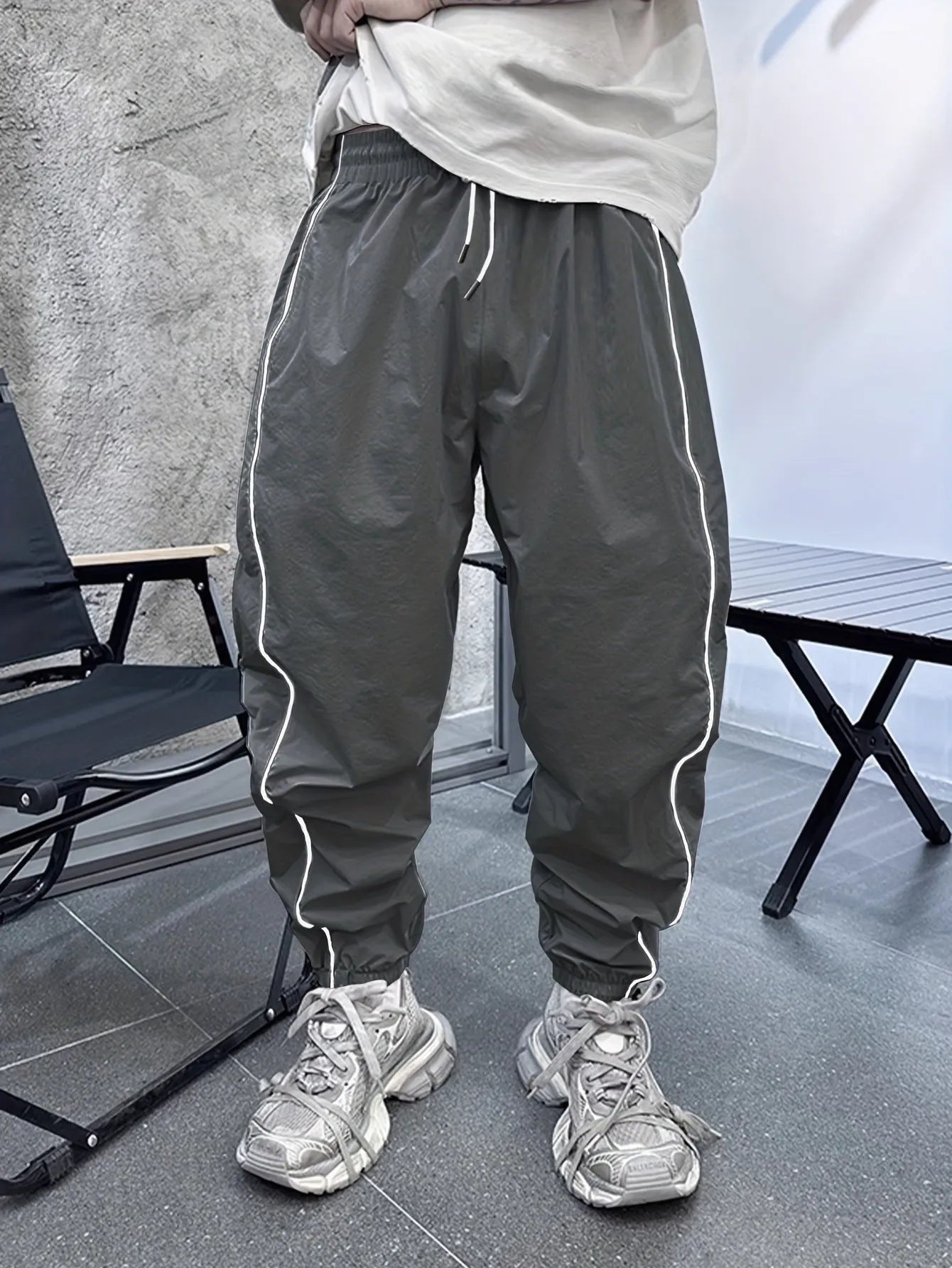 Man wearing loose, cropped blue bamboo fibre casual trousers.