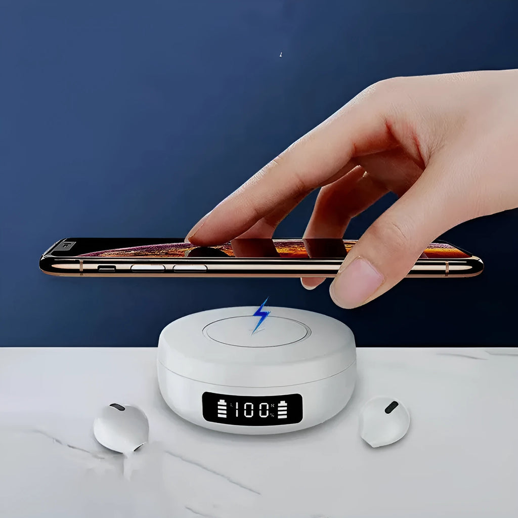 Mini black and white semi-in-ear wireless headphones with their wireless charging case on a table.