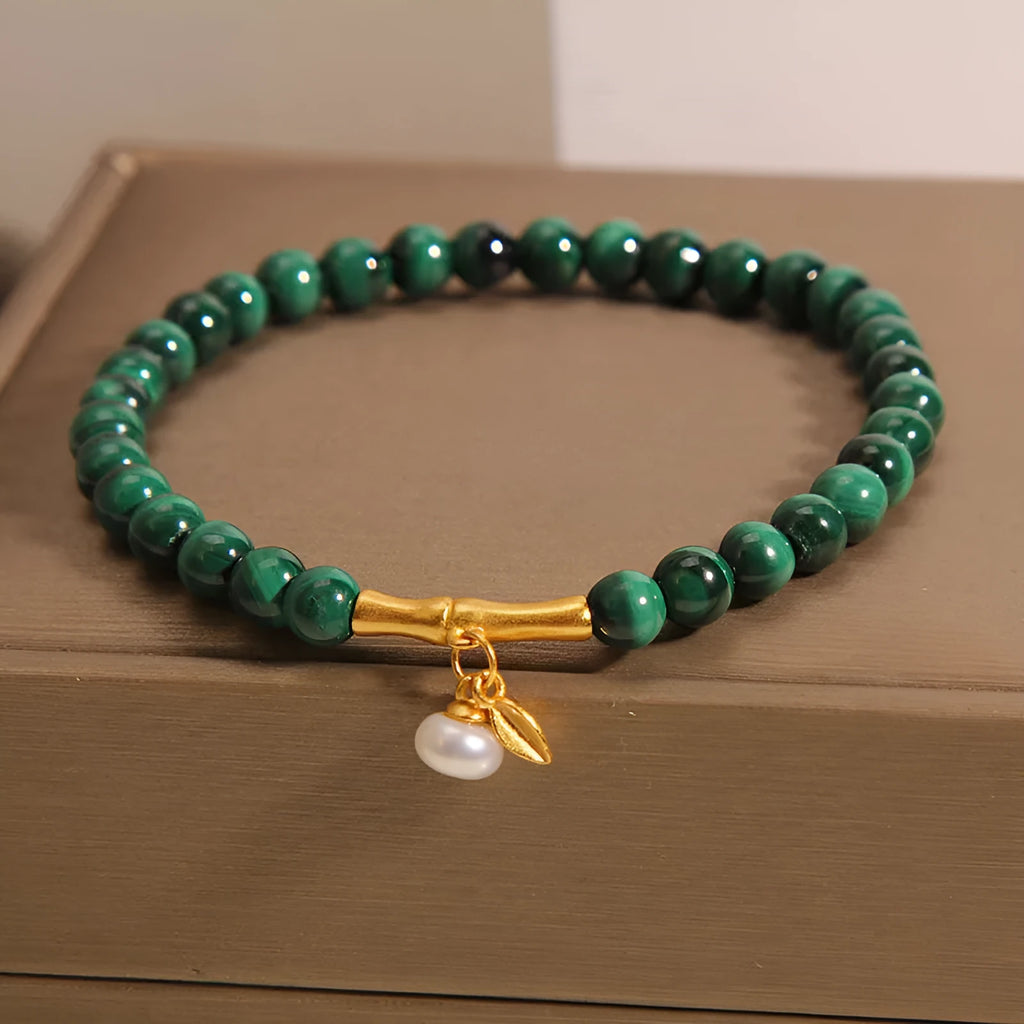 Women's white crystal lucky bamboo bracelet with adjustable clasp on a wrist.