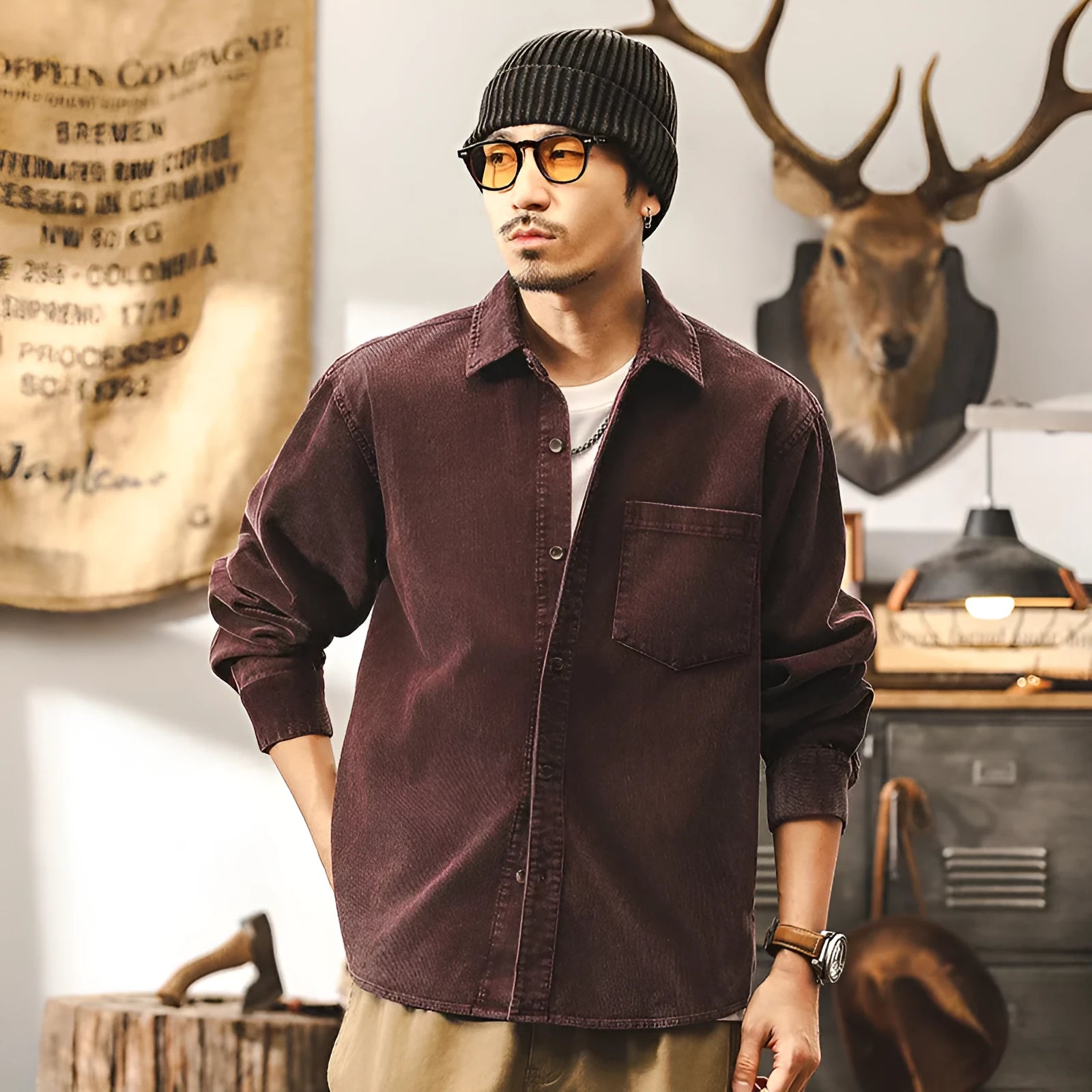 Man wearing a loose-fit red corduroy shirt jacket, showcasing its textured fabric and casual style.