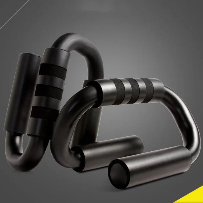 Black S shape push-up bracket rack on a home gym floor