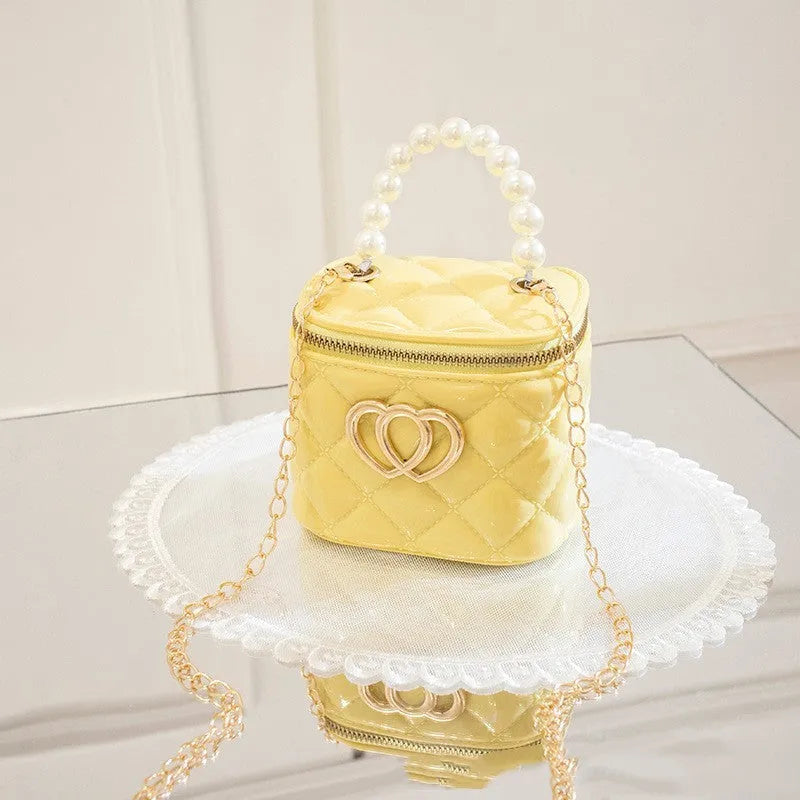 Women's PVC bucket gel bag with heart-shaped pattern in assorted colours.