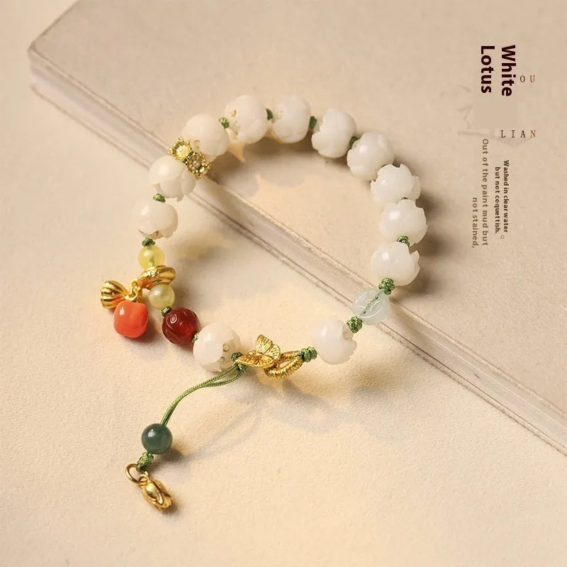 White jade Bodhi bracelet with lotus beads and a large pumpkin bead on an open rope.