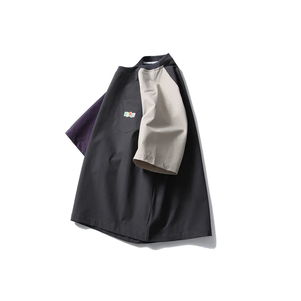 Dark grey men's quick-dry T-shirt with contrast colour raglan sleeves on a hanger.