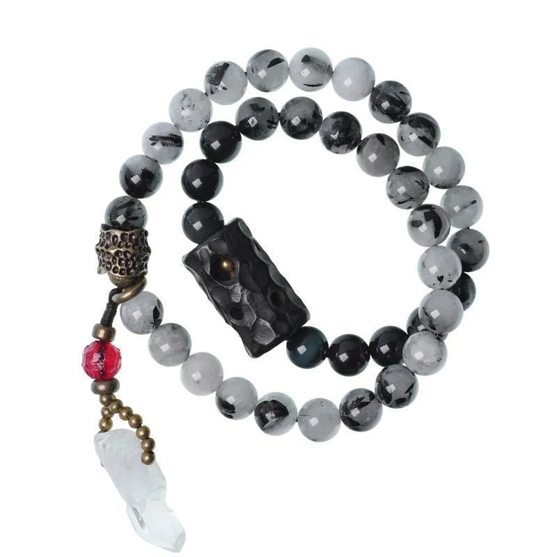 Ethnic black hair bracelet with white crystal tassel showing bending and lacing construction