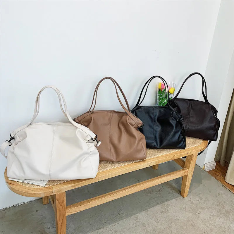 Large soft-surface PU messenger tote bag in black with zipper opening and adjustable shoulder strap